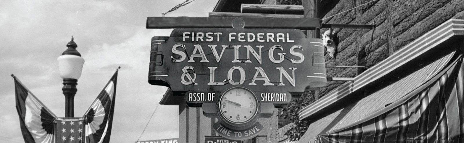 Black and white photo of the First Federal Savings & Loan sign on Main St. in the 1930s.